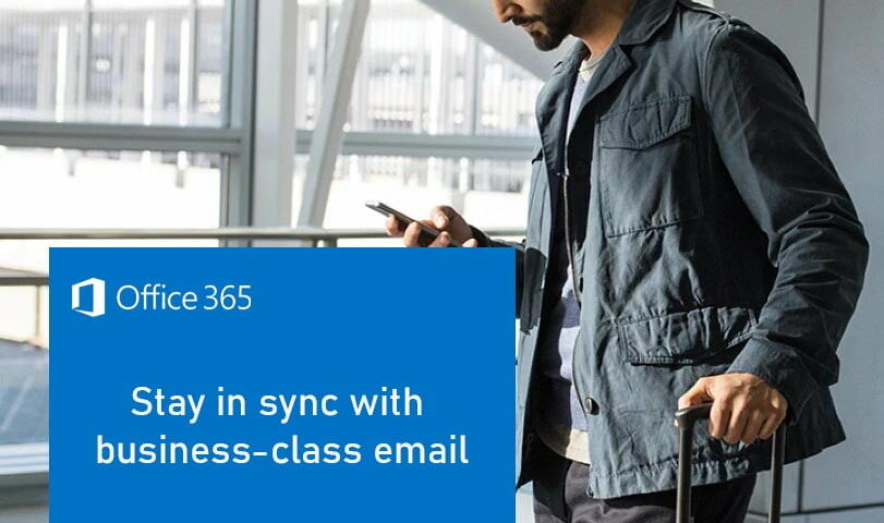 Man in an airport holding a phone